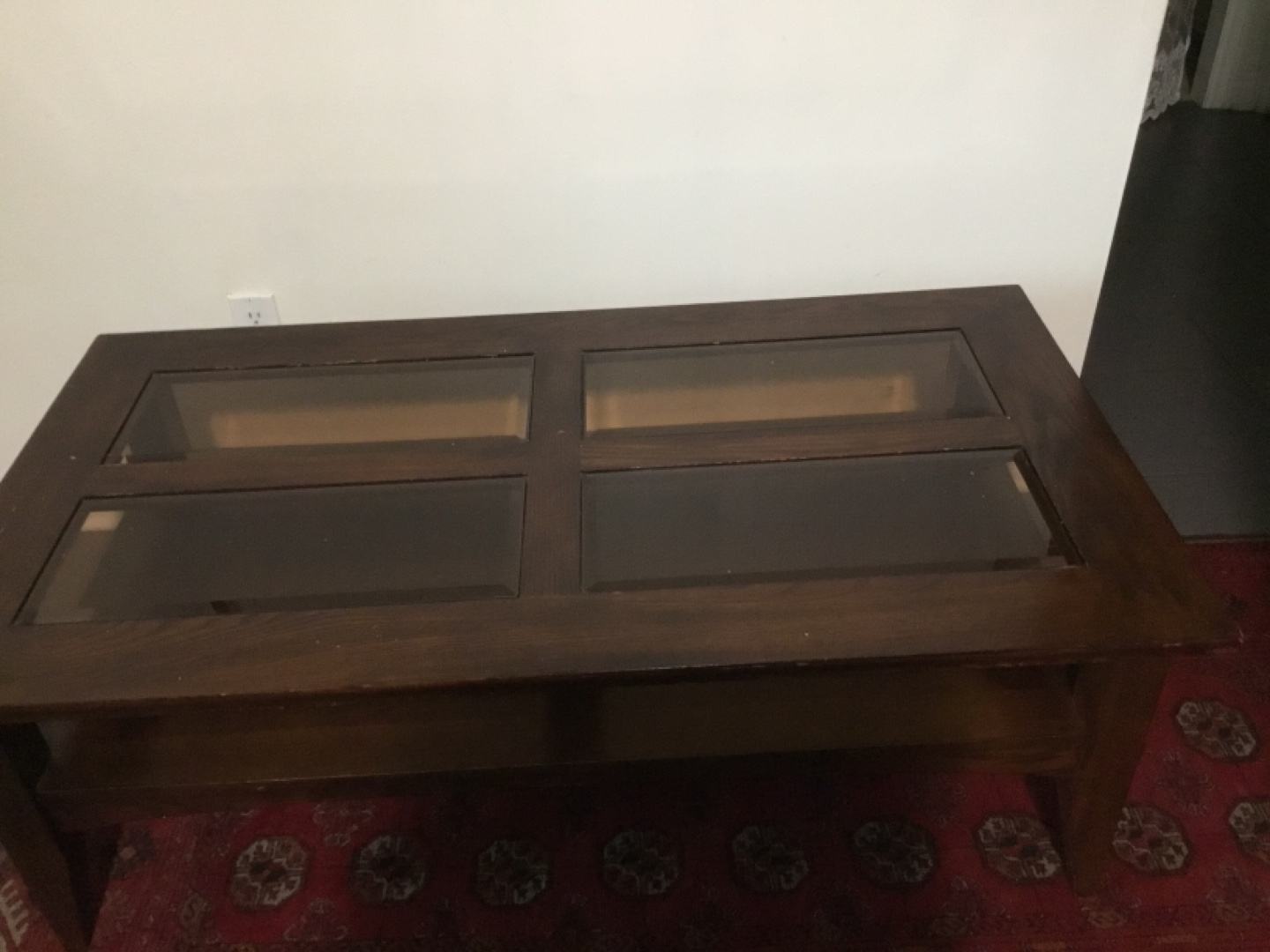 Dark brown wooden coffee table with glass top