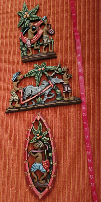 Three hand-carved wooden wall hangings