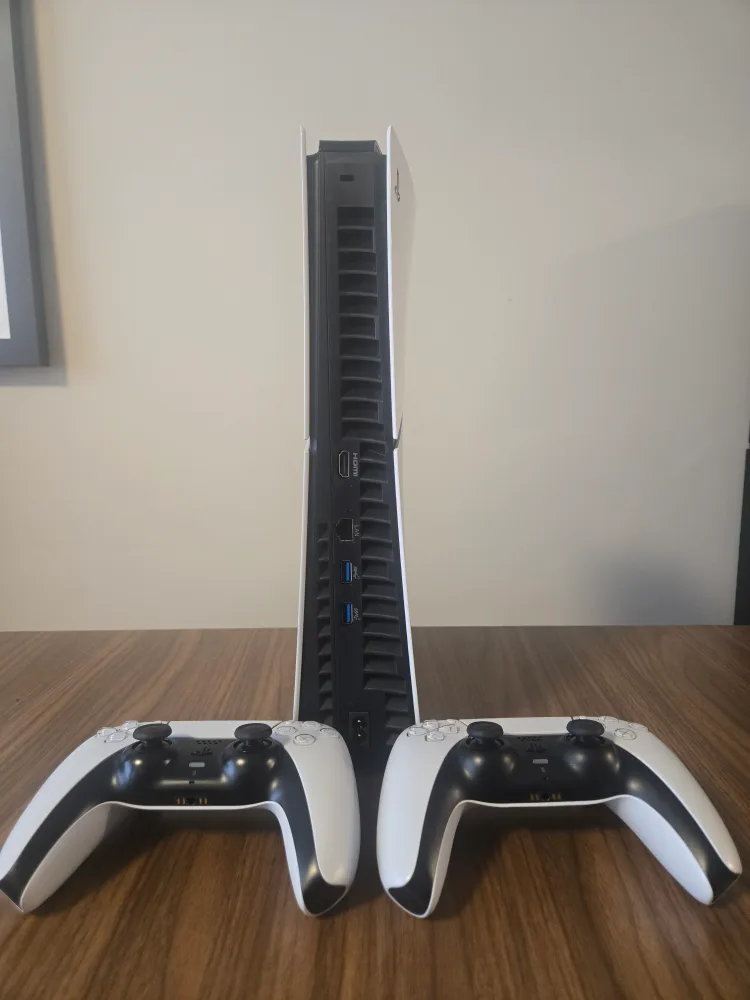 PS5 Console with Two DualSense Controllers image indicator(2)