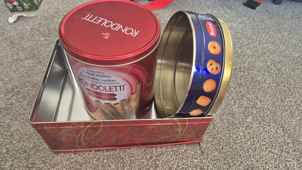 Three empty vintage biscuit tins