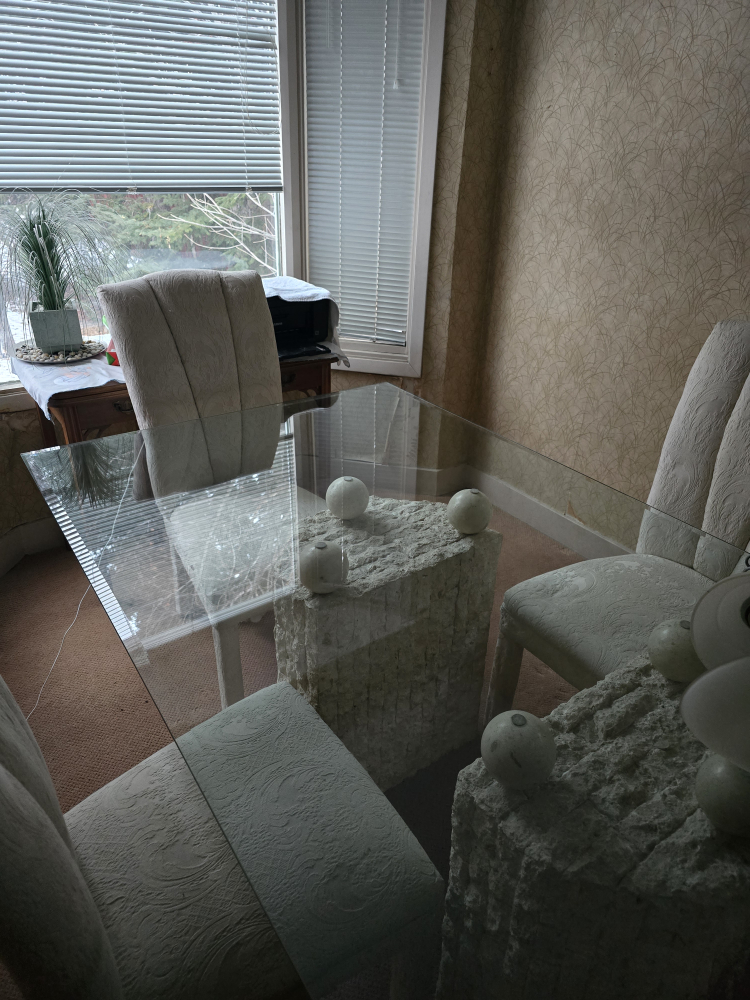 Glass-top dining table with unique stone base and four chairs - photo 2