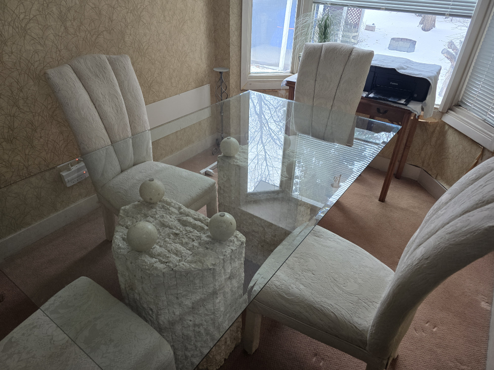 Glass-top dining table with unique stone base and four chairs - photo 4