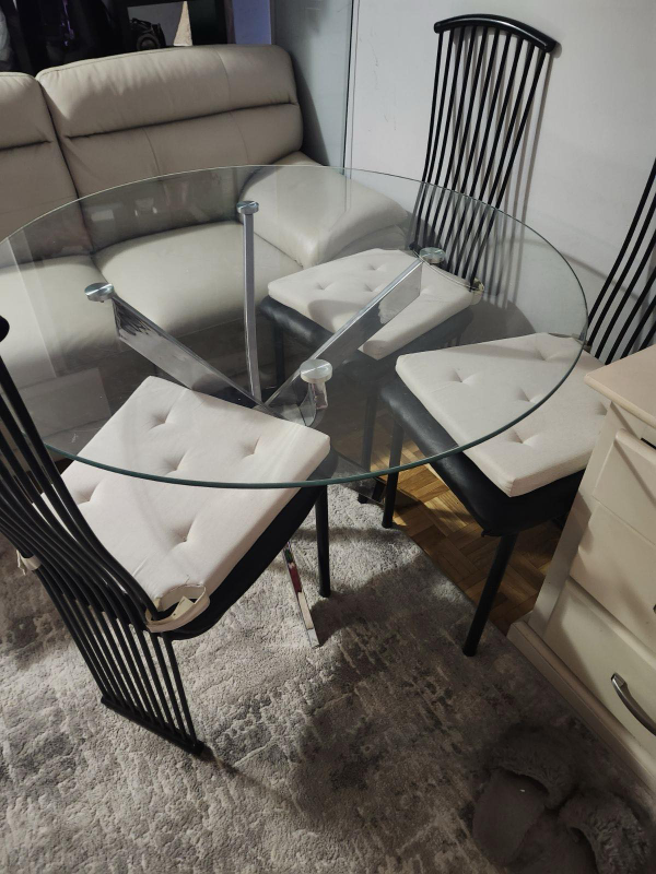 Glass-top dining table with four chairs