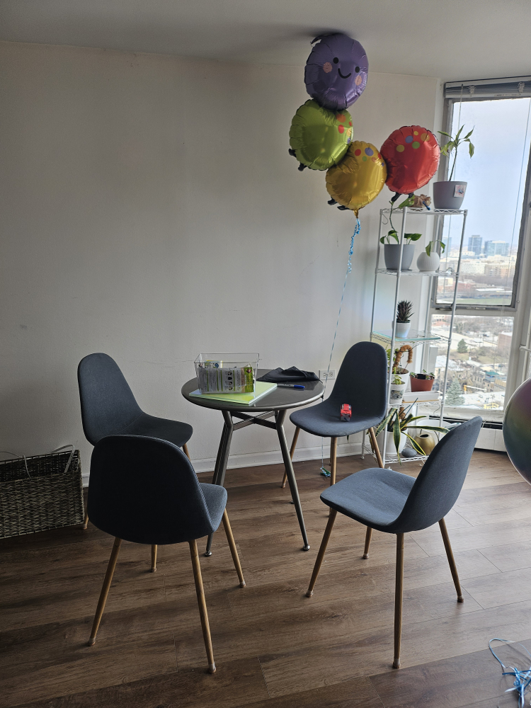 Set of four dark gray dining chairs with wood legs