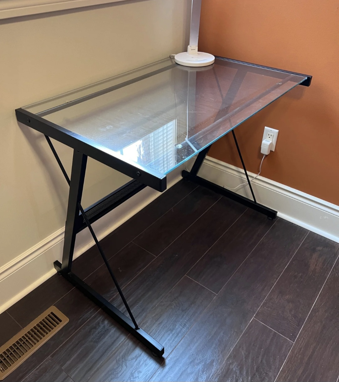 Glass top computer desk with a damage on one corner