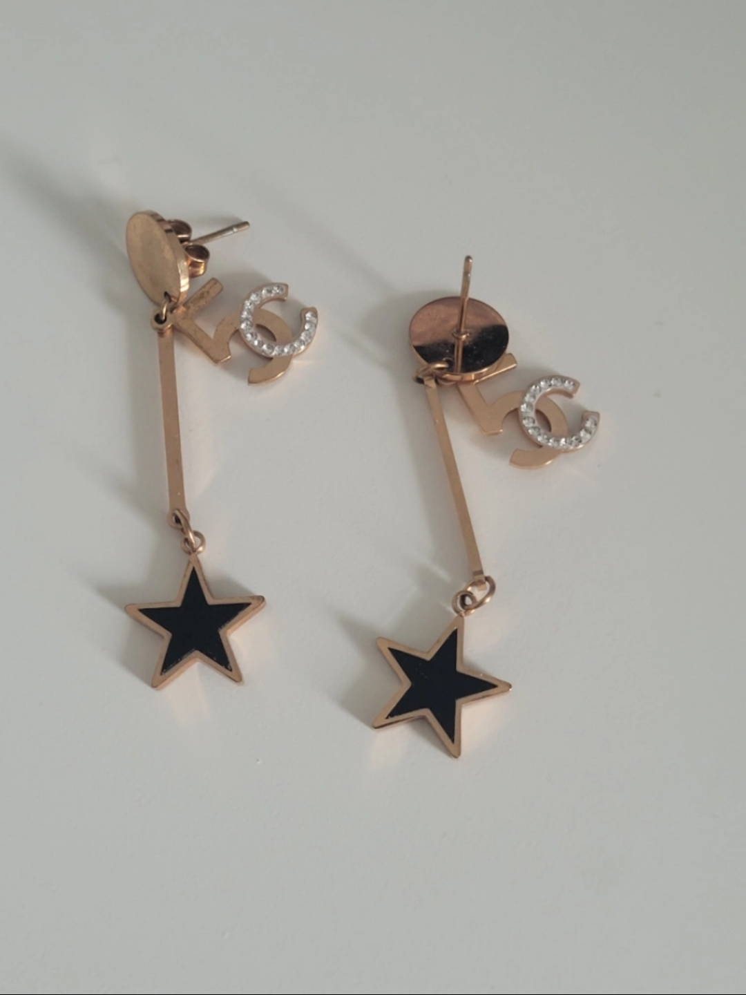 Gold tone Chanel inspired earrings with black star accents