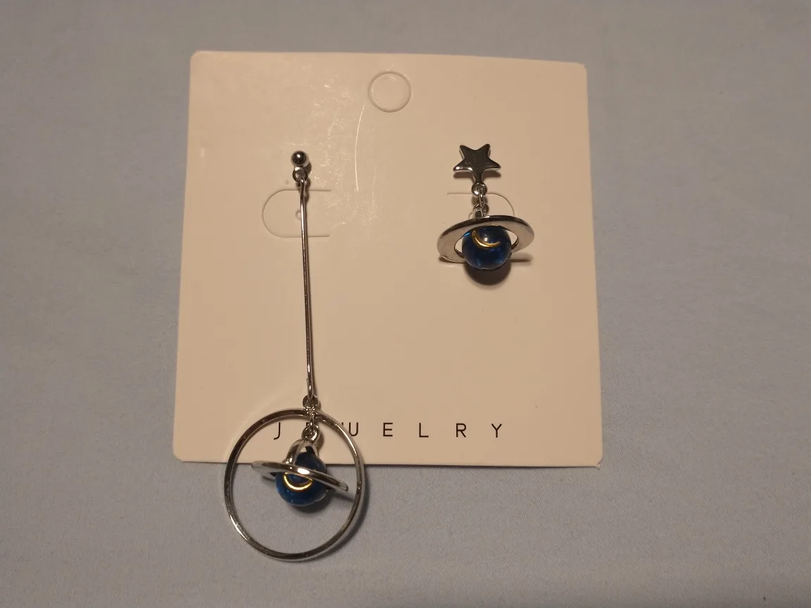 Asymetrical blue and silver star and planet earrings image indicator(2)