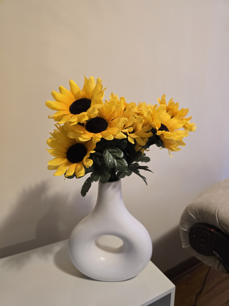 White ceramic vase with sunflowers