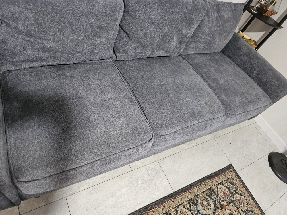 Grey fabric sofa with three cushions