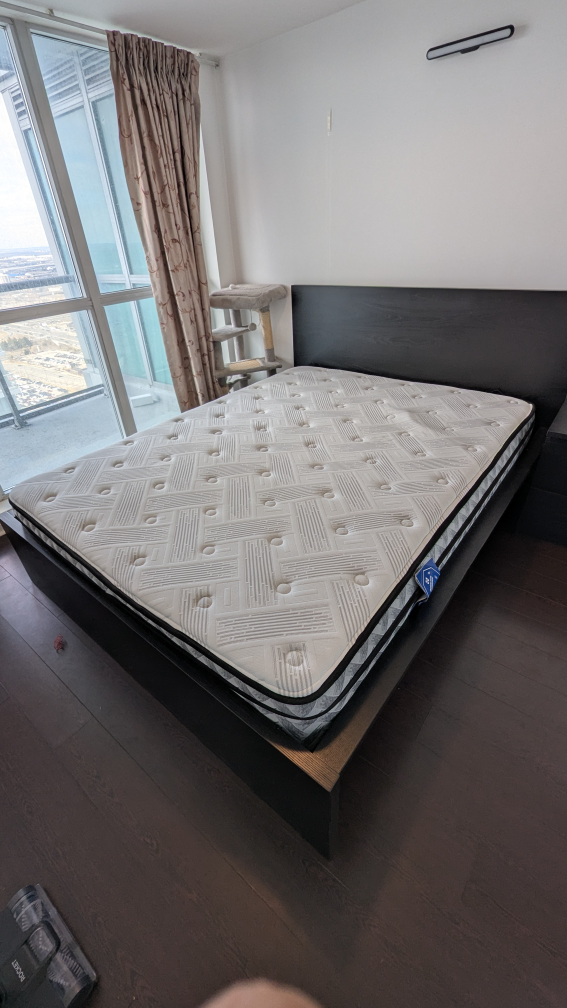Queen-size bed frame with mattress