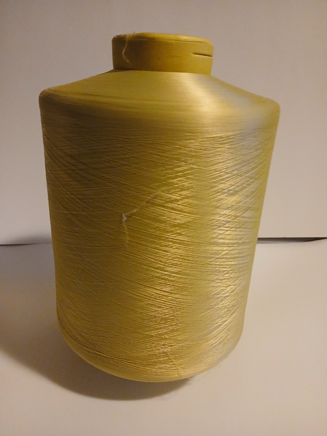 Large spool of yellow /gold thread/yarn