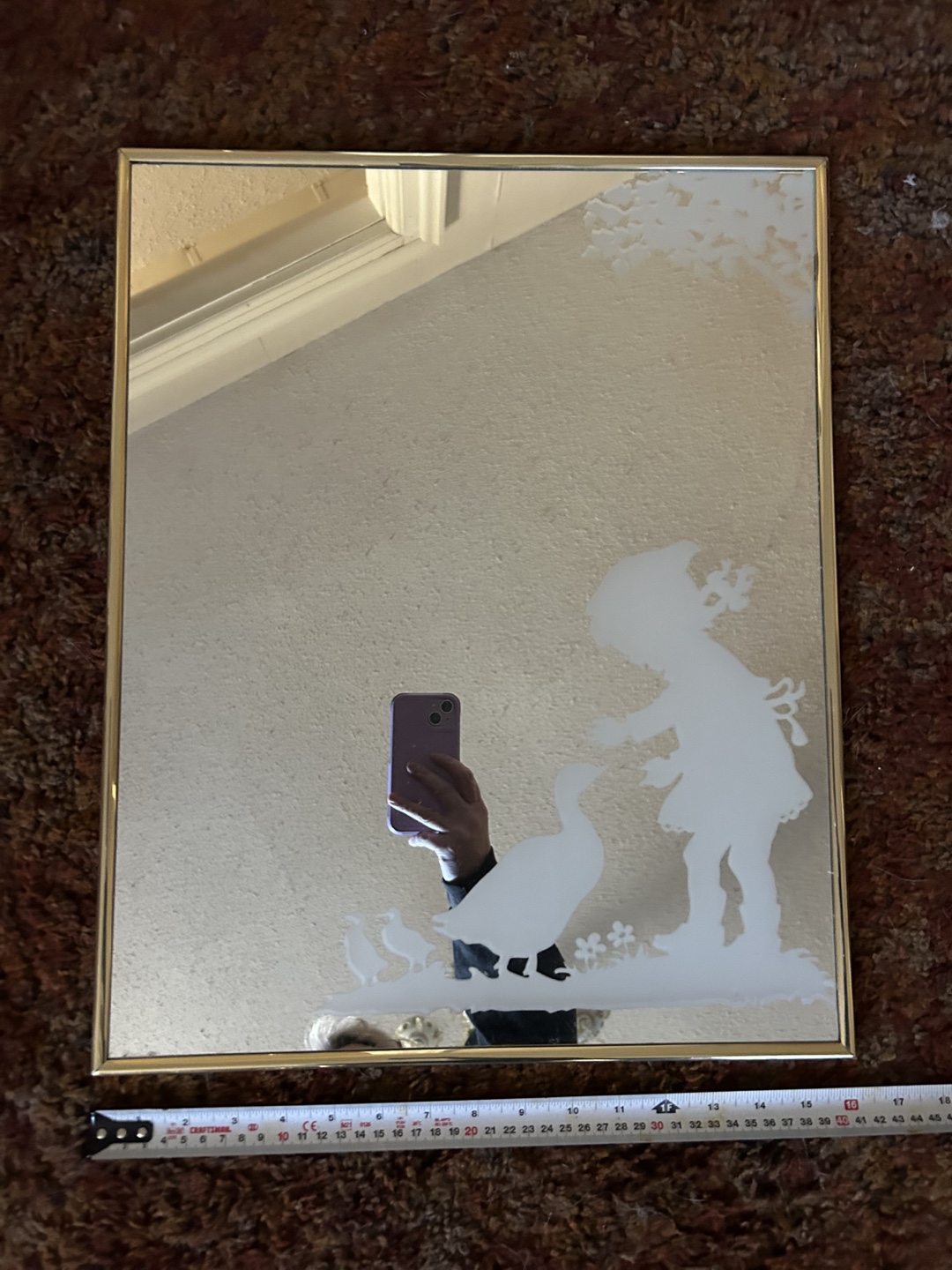 Mirror with little girl feeding a goose