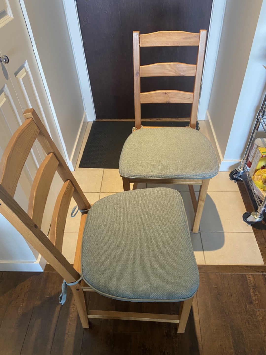 Pair of IKEA wooden chairs with light teal cushions - photo 2