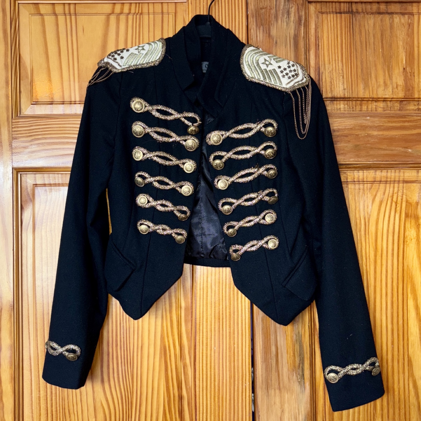 Black cropped military-style jacket with gold embellishments