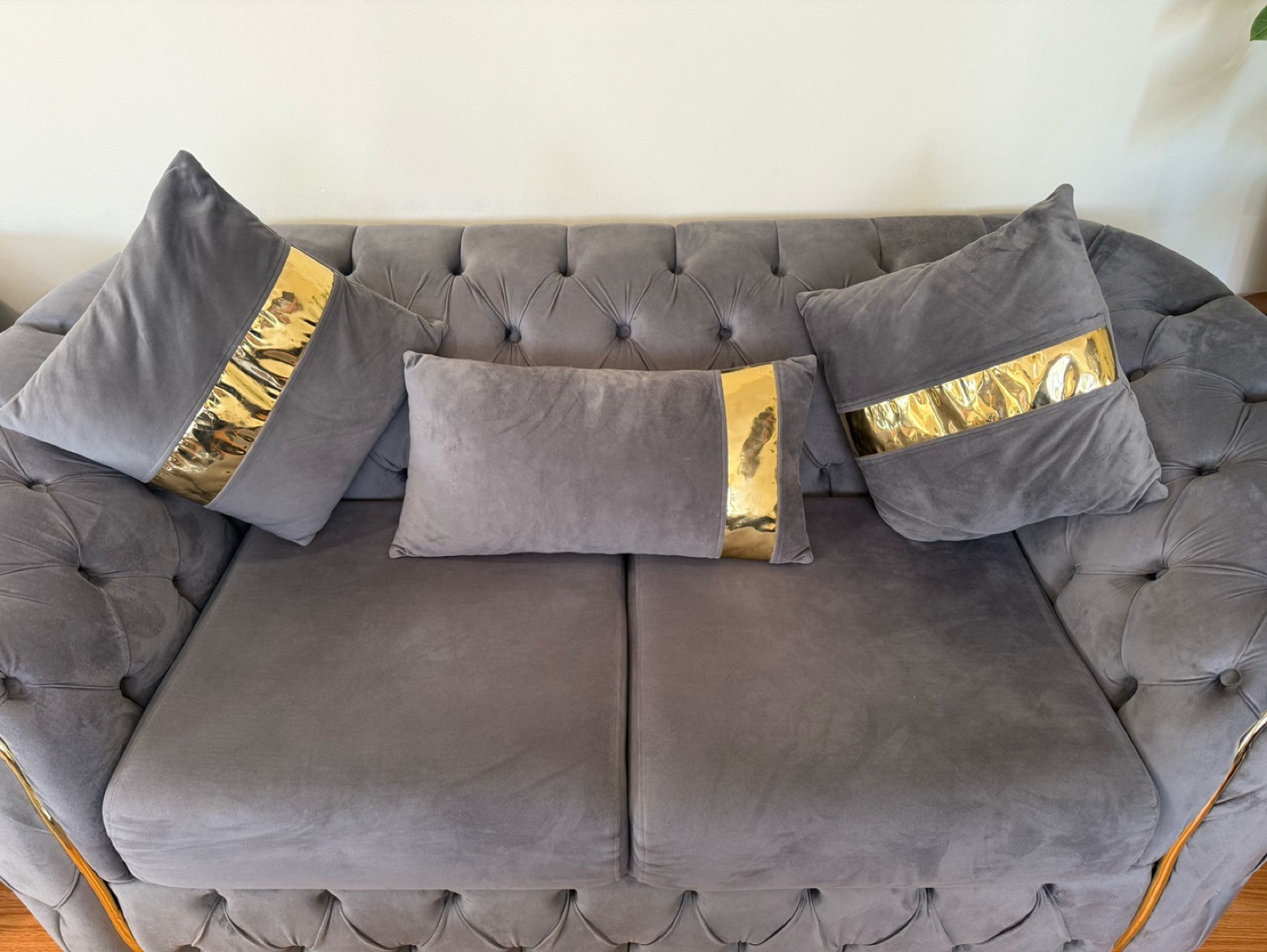 Grey Velvet Sofa with Gold Accent Pillows