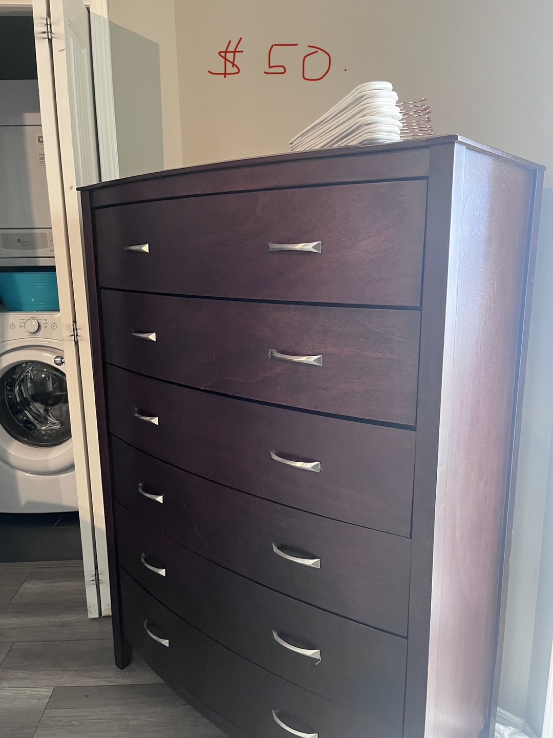 Dark brown wooden dresser with six drawers
