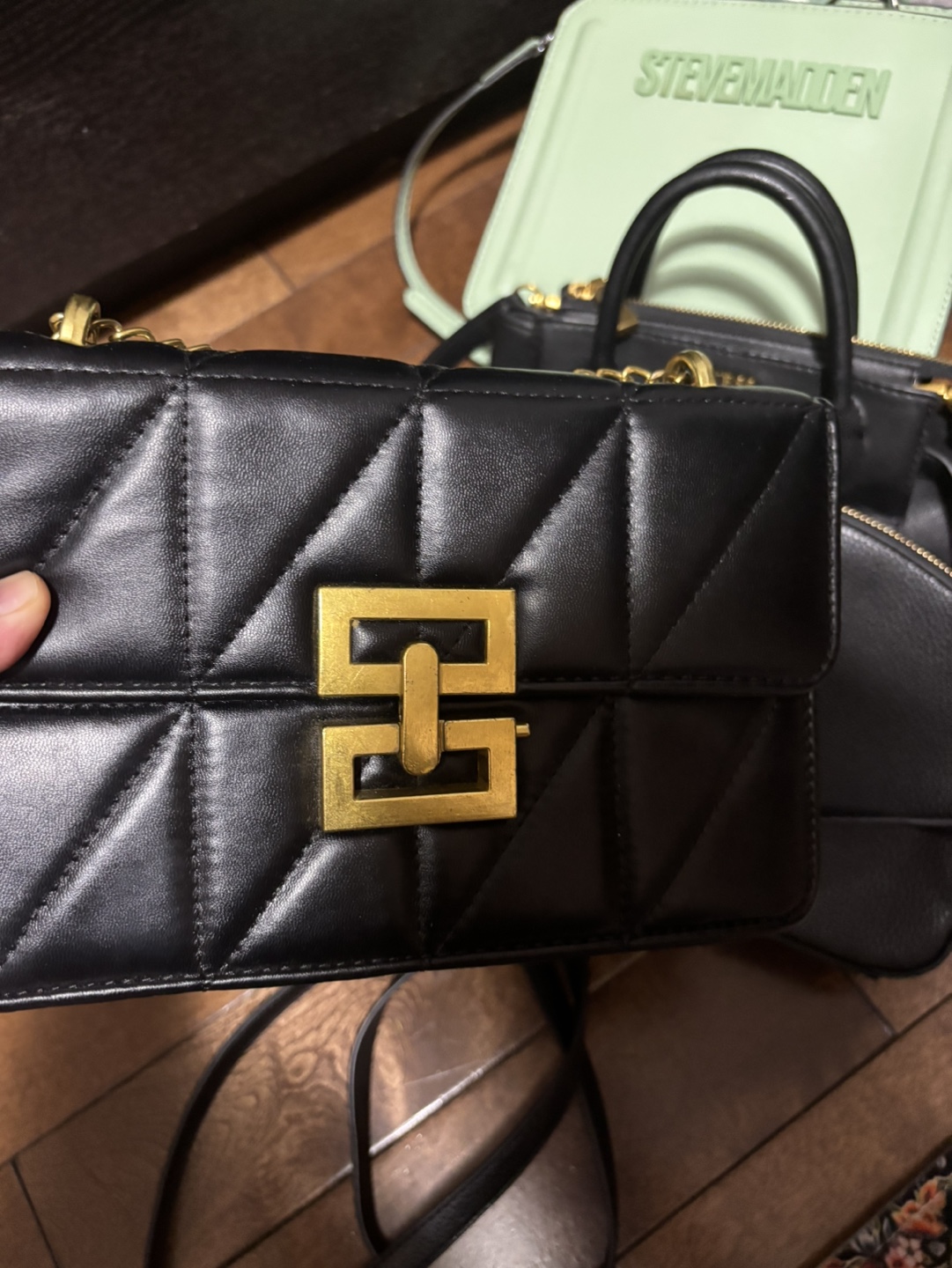 Black quilted crossbody bag with gold chain strap