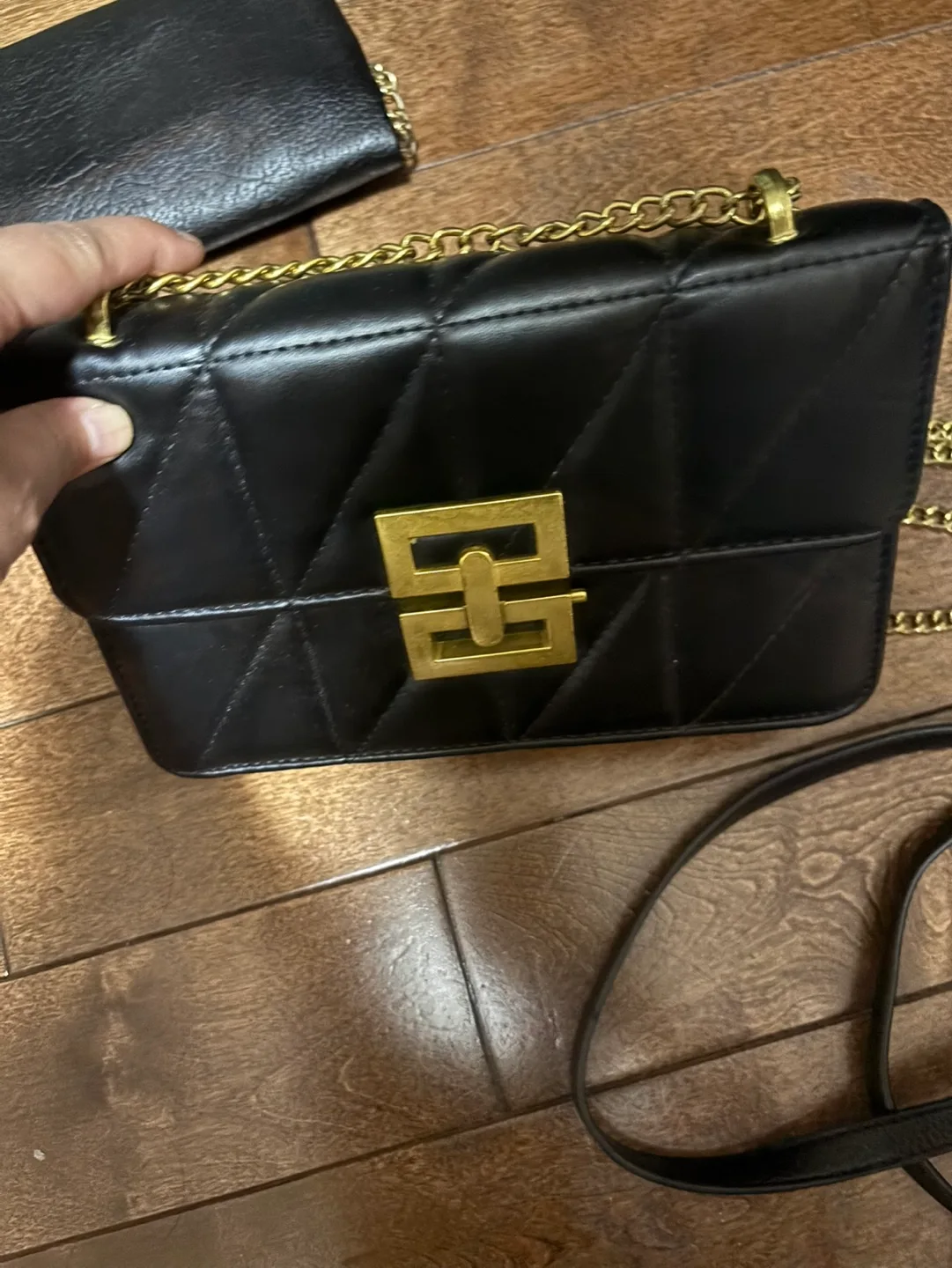 Black quilted crossbody bag with gold chain strap image indicator(3)