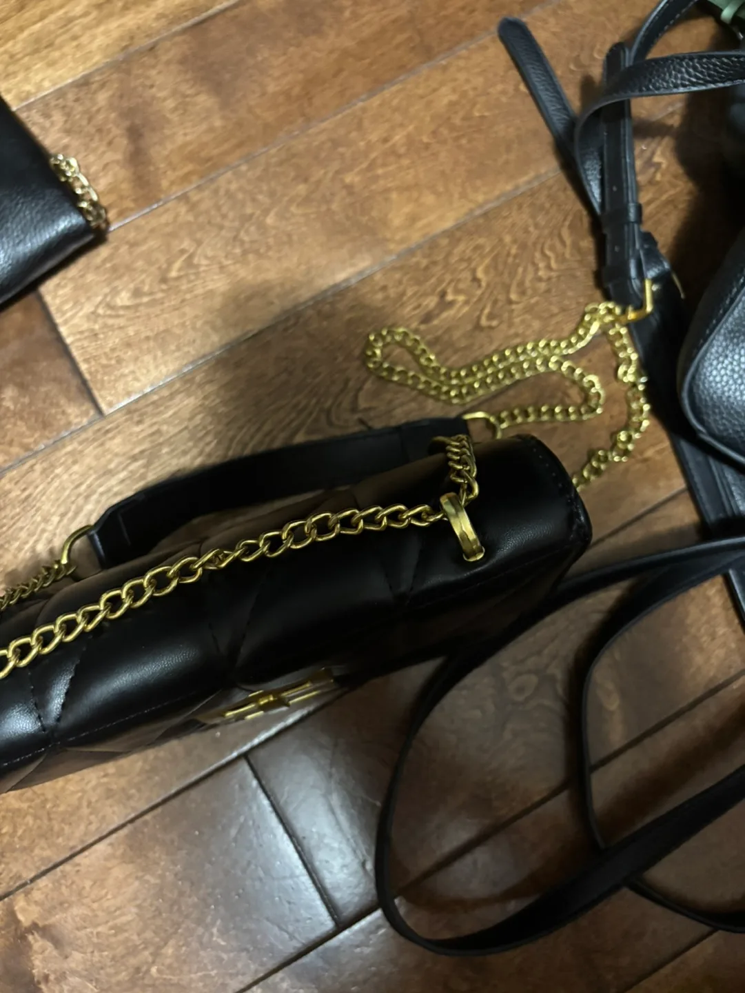 Black quilted crossbody bag with gold chain strap image indicator(2)