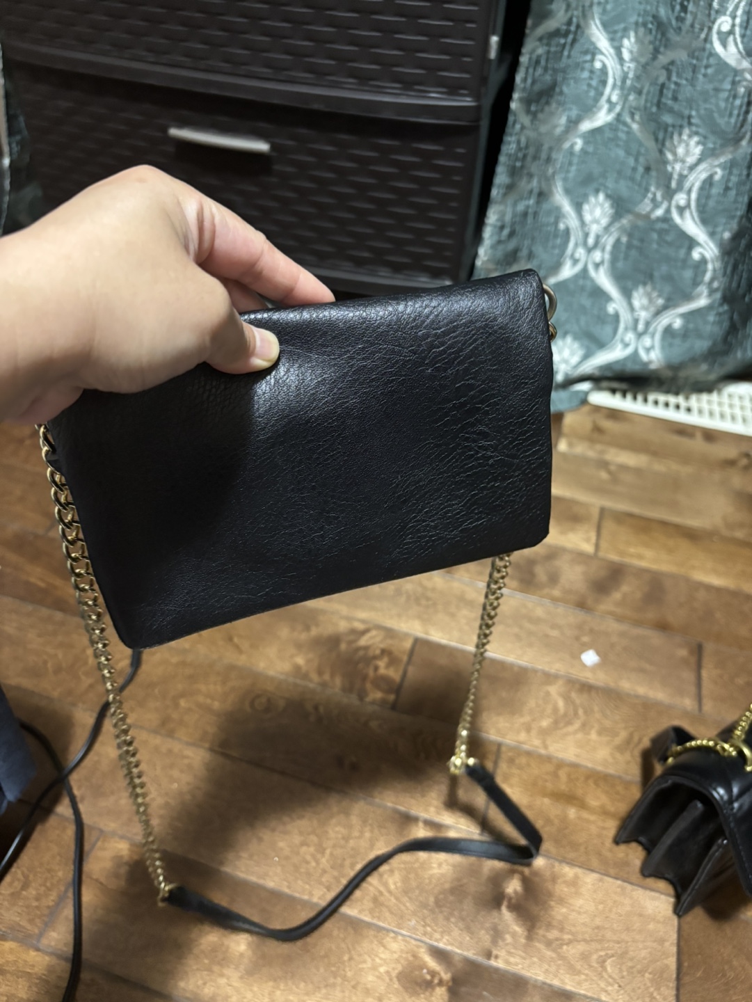 Black crossbody bag with gold chain strap