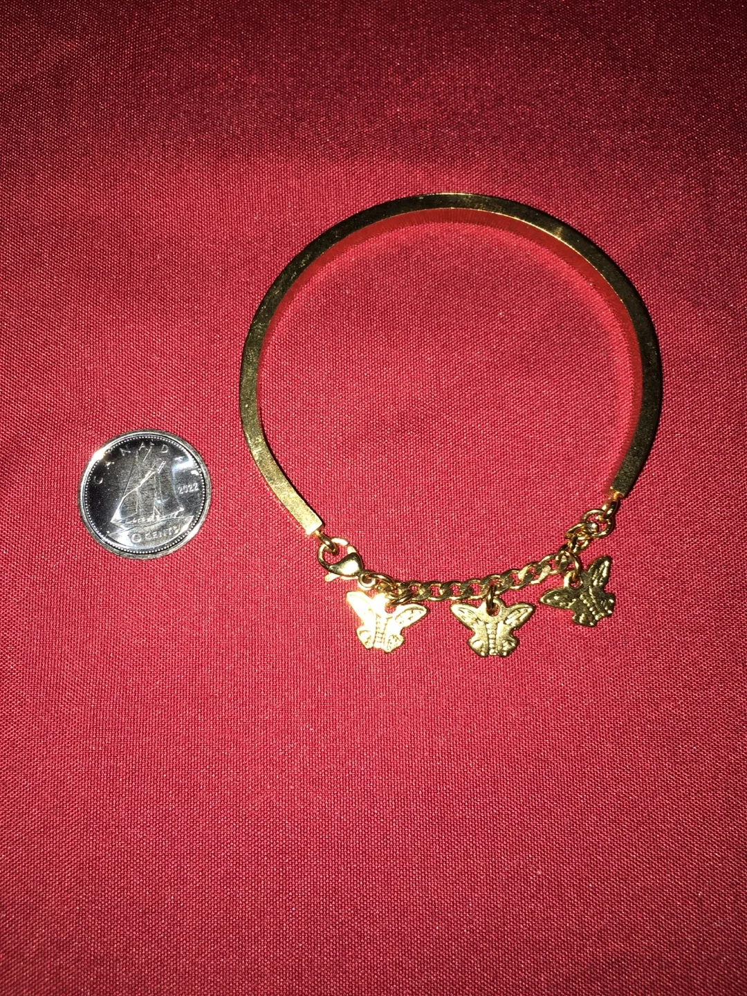 Gold-tone bracelet with butterfly charms image indicator(4)