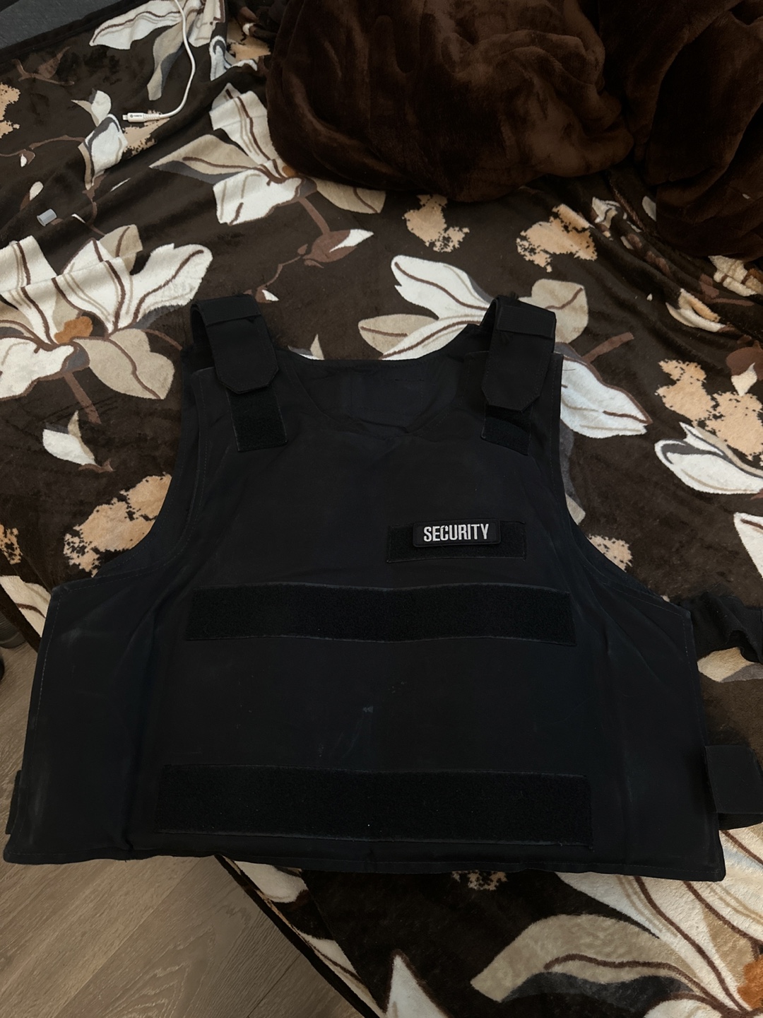 Black Security Tactical vest with built-proof plates .