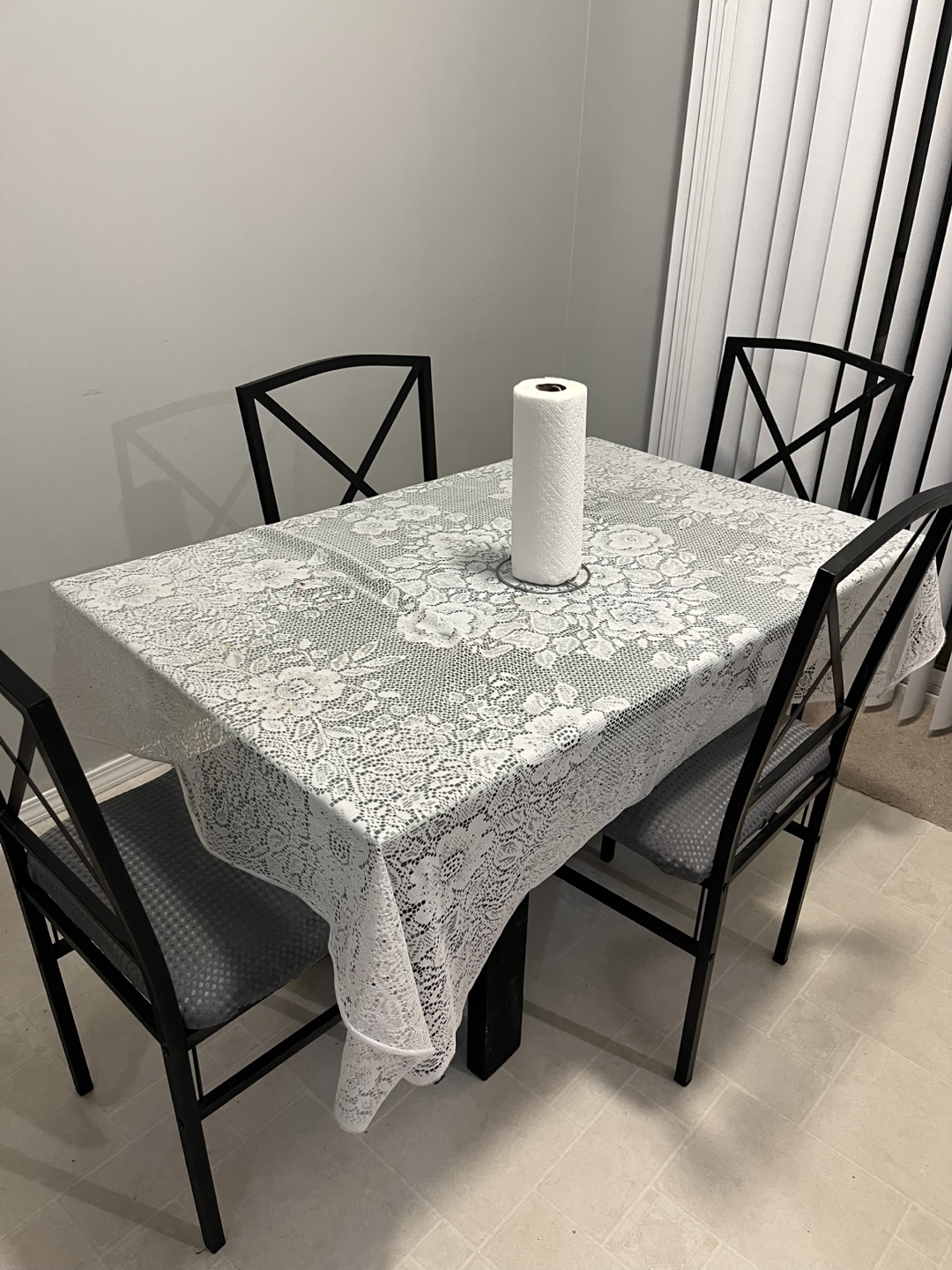 Glass-top dining table with four chairs