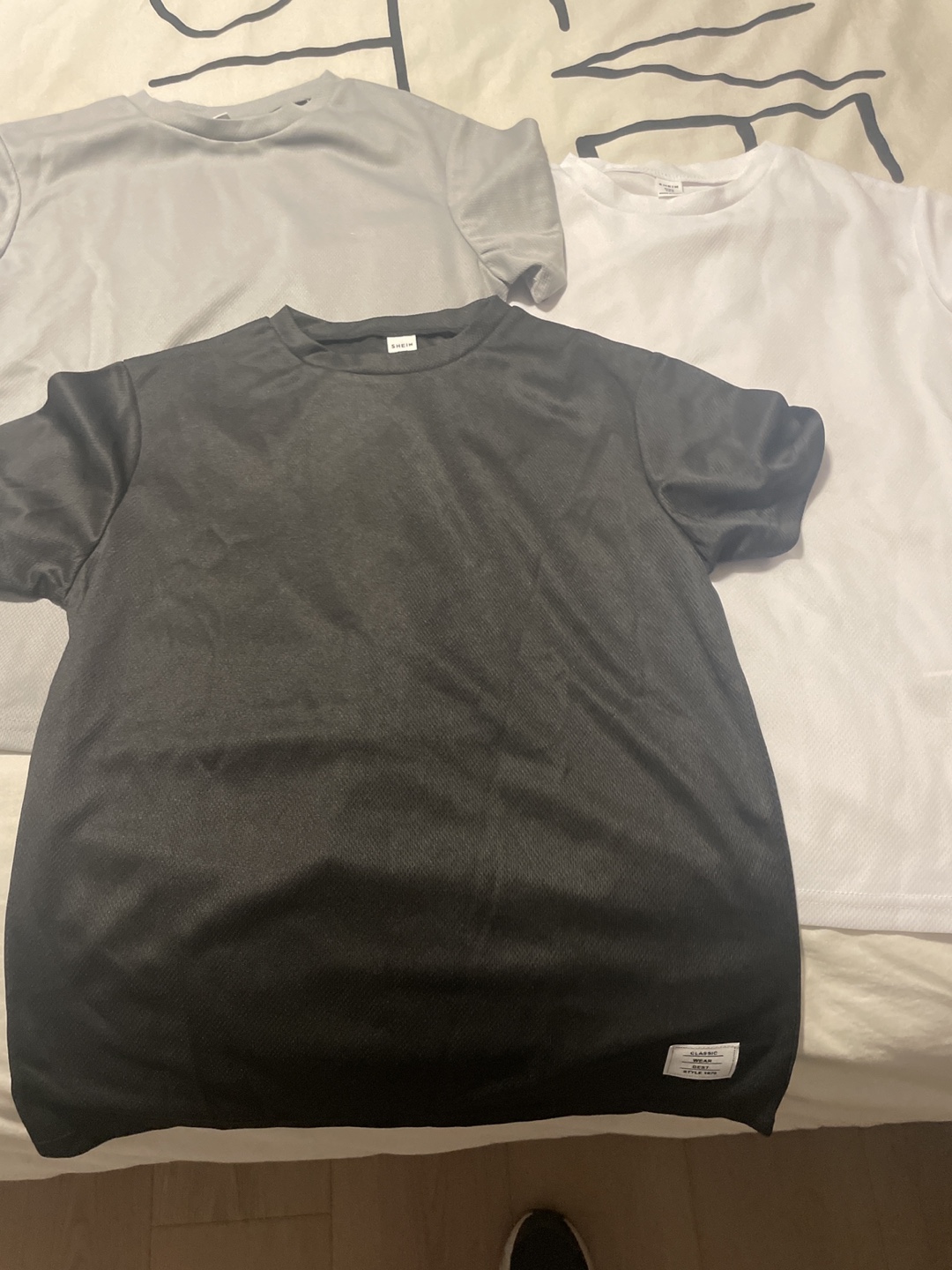 Three SHEIN T-Shirts - Grey, White, and Black