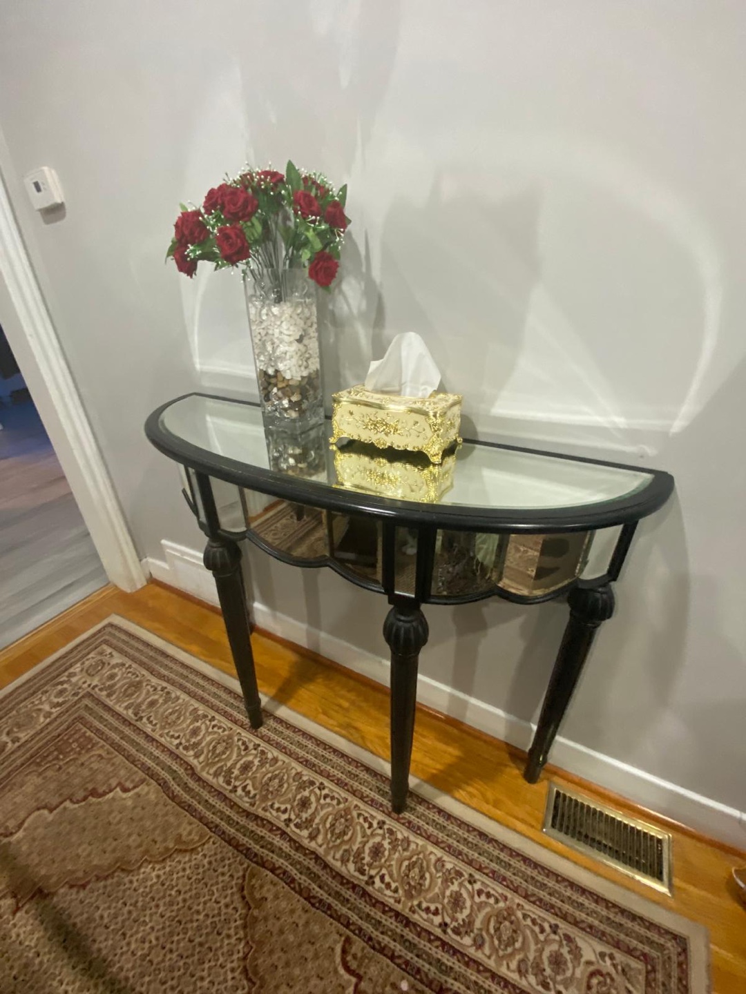 Black mirrored half-moon console table