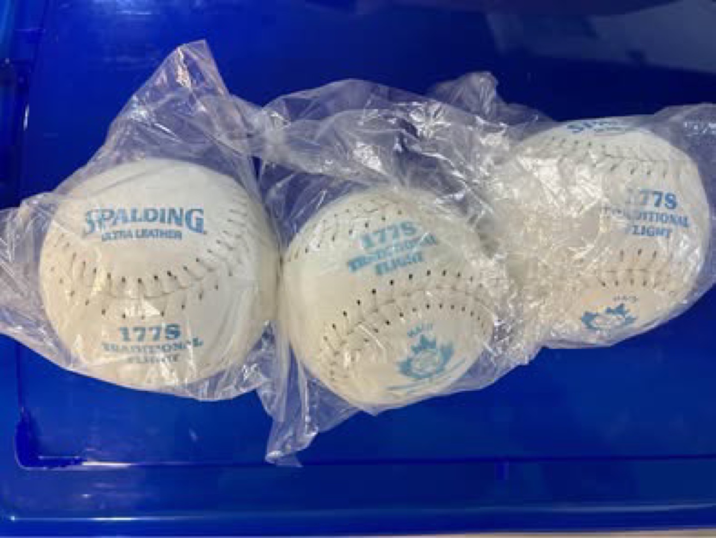 Three Spalding 177STraditional Flight Softballs