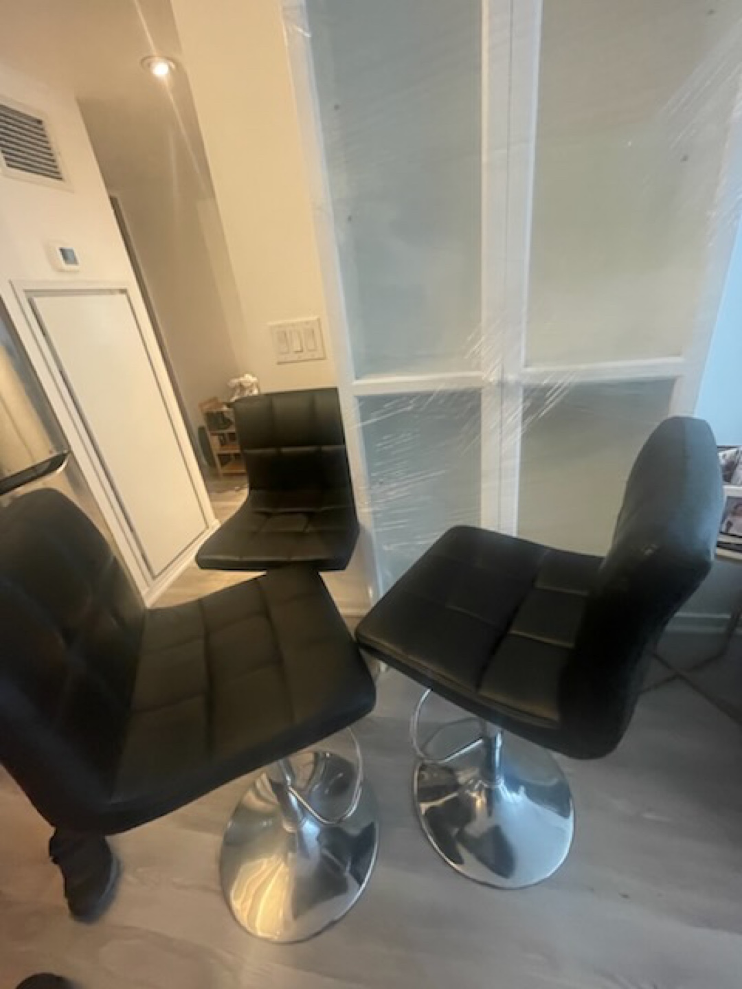 Set of three bar stools. Black faux leather  back
