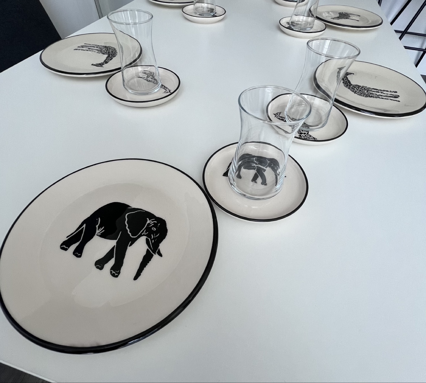 Set of six animal-themed plates and saucers