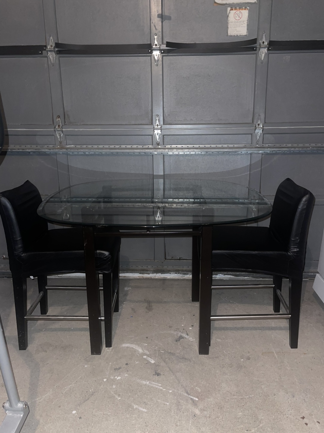 Glass-top dining table with two chairs