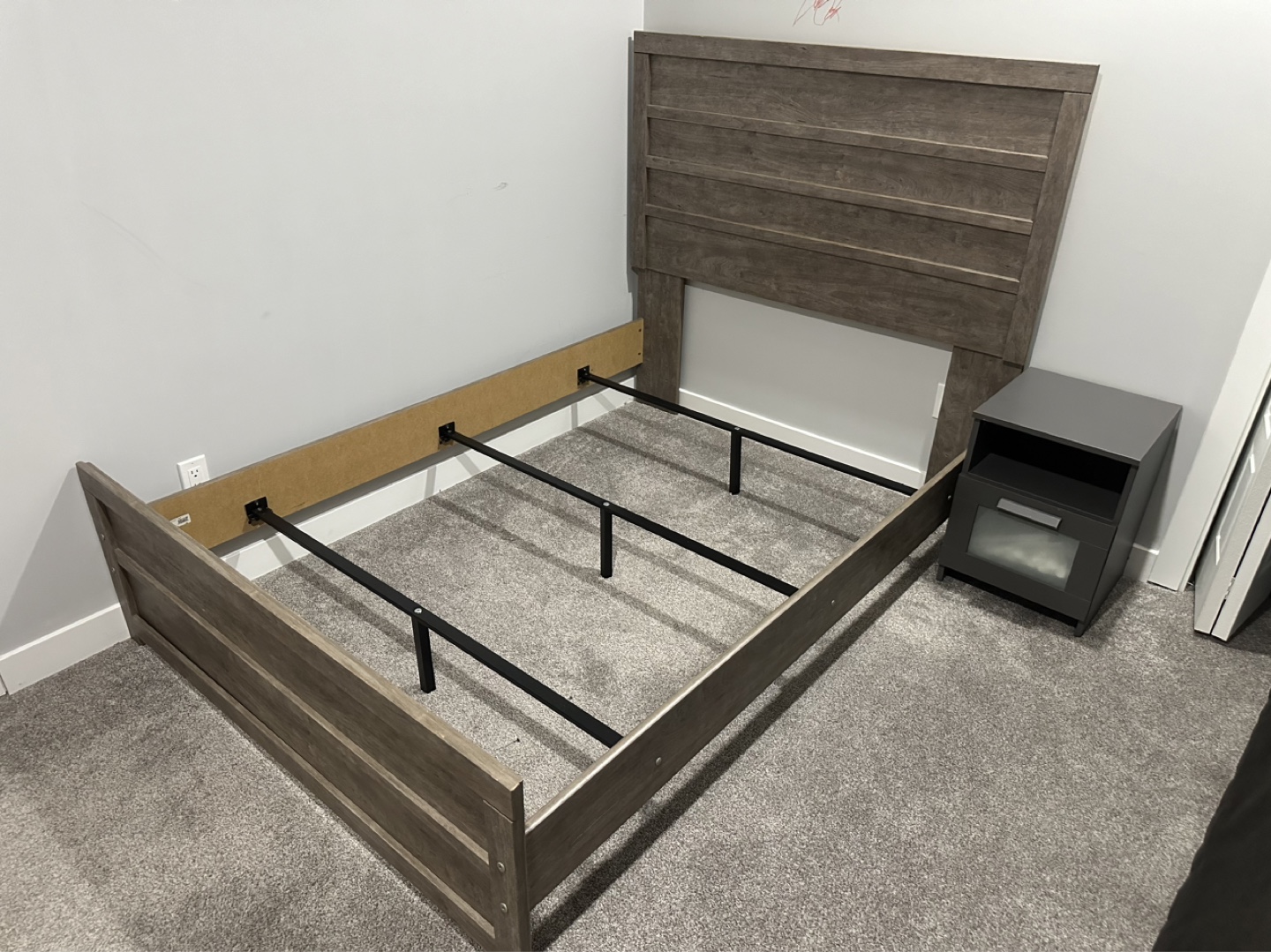 Twin-size bed frame with headboard and mattress