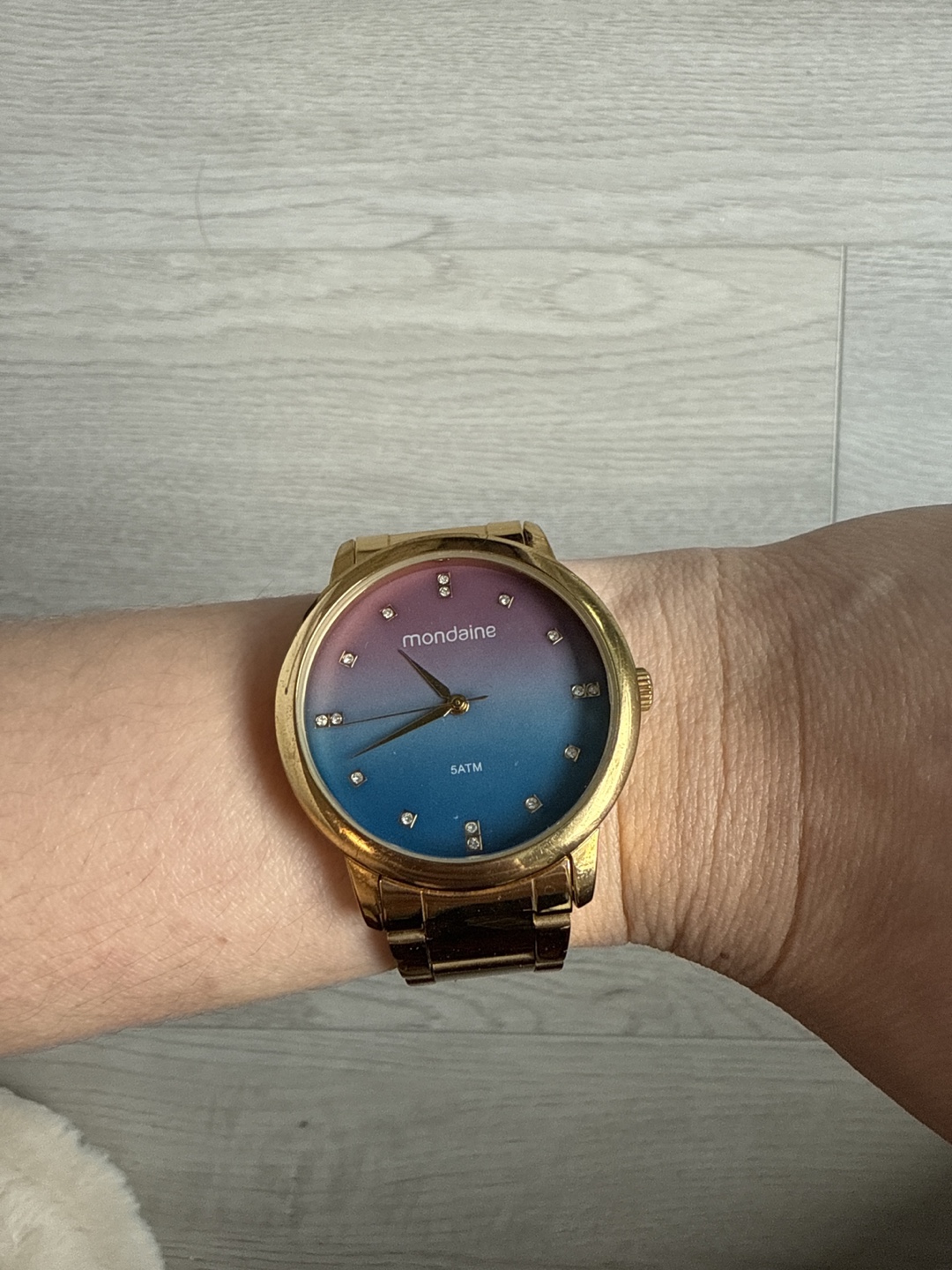Mondaine gold tone watch with ombre face