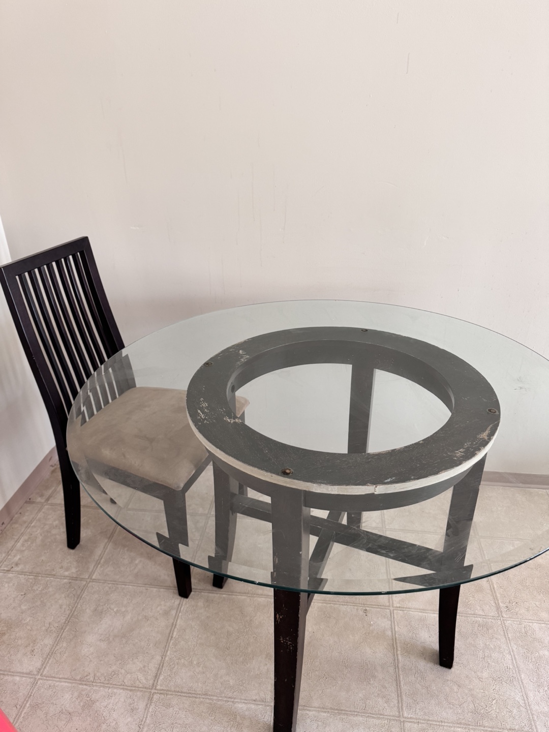 Glass-top dining table set with two chairs