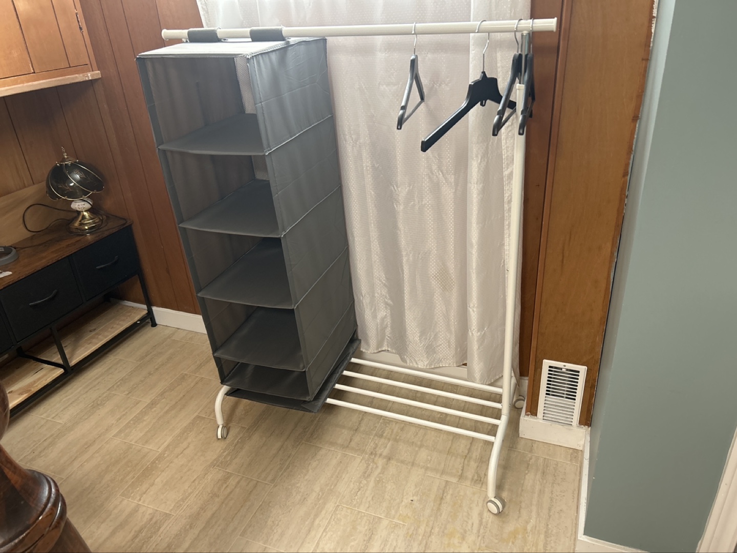 White garment rack with grey fabric shelves