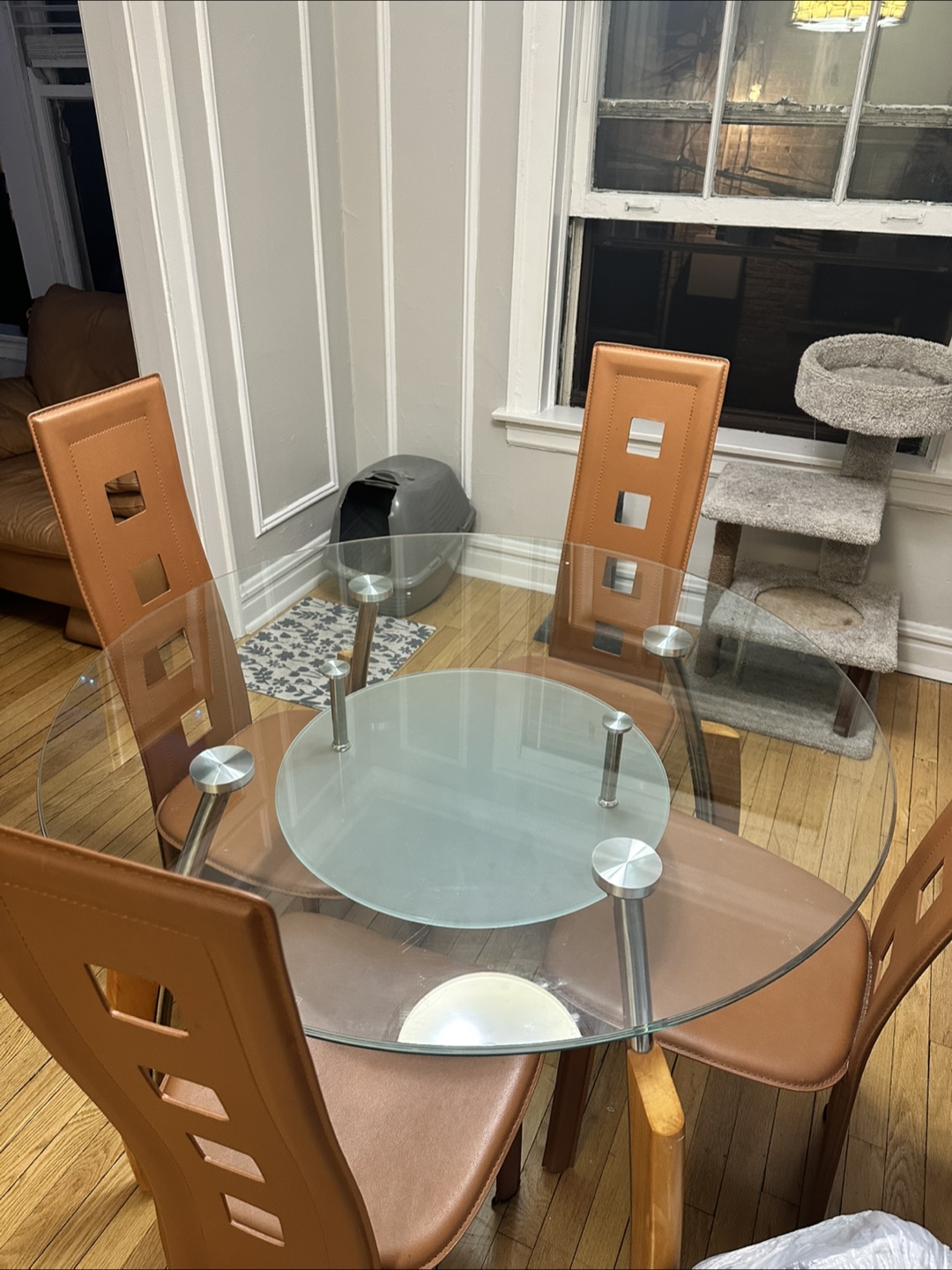 Glass Dining Table with Four Brown Chairs
