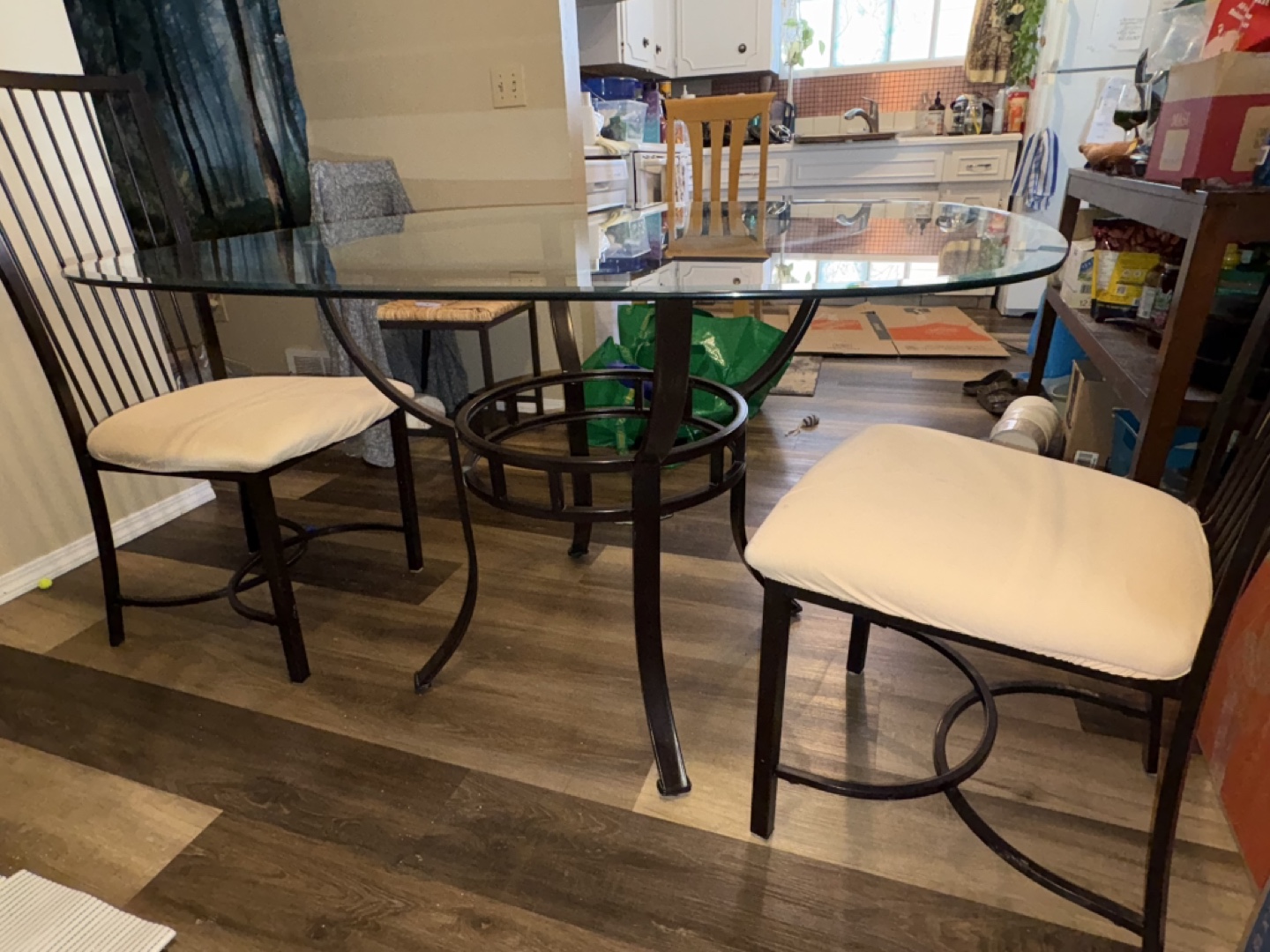 Glass-top dining table with two chairs