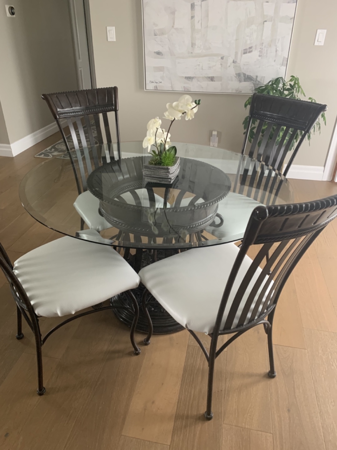 Glass-top dining table set with four chairs
