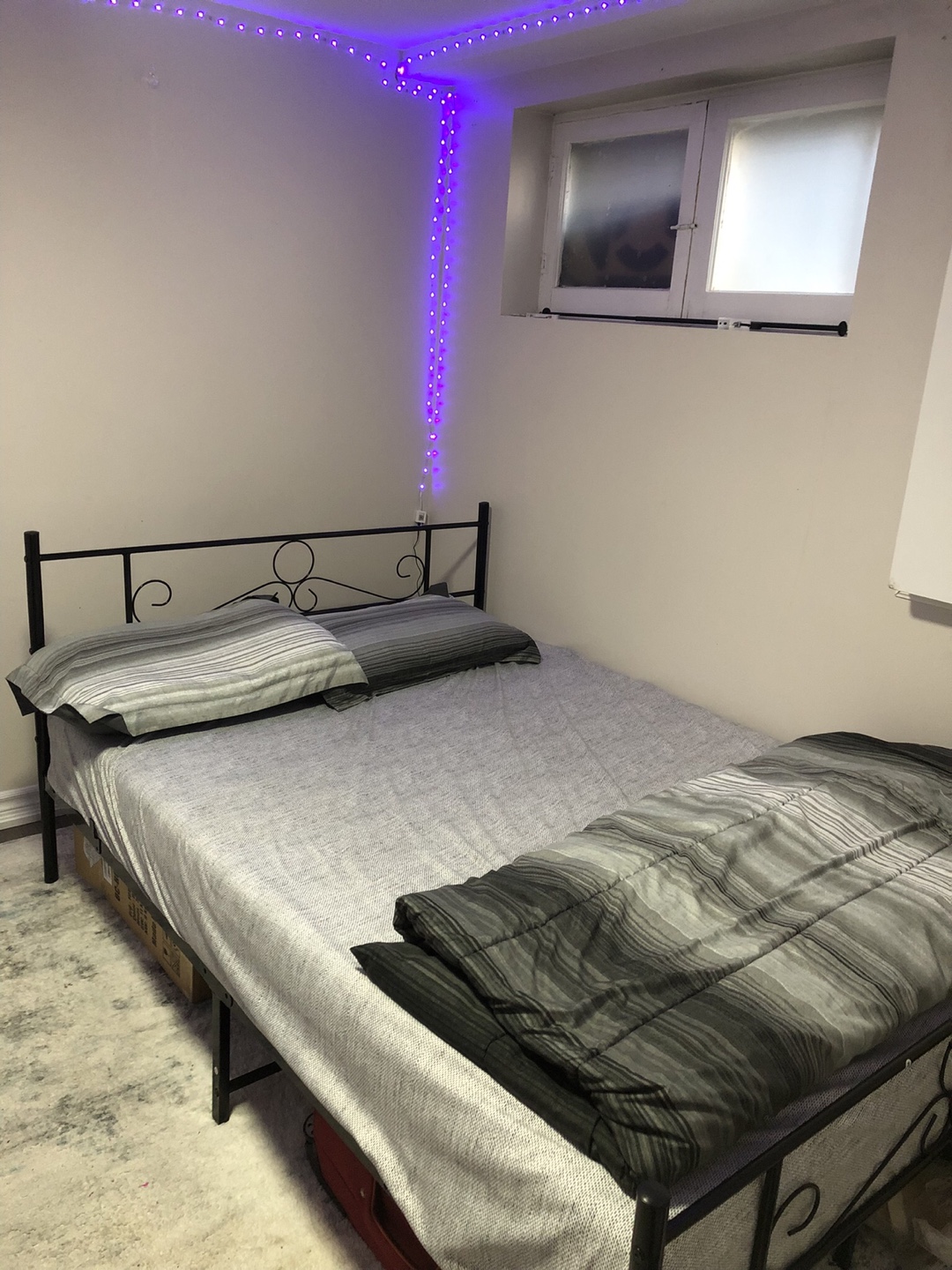 Double bed frame with grey bedding