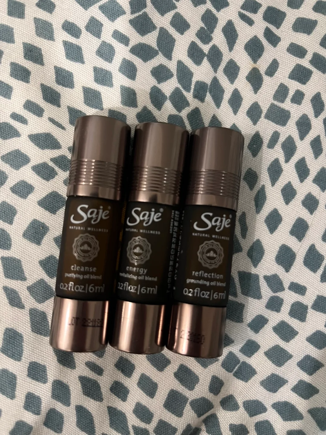 Three Saje Natural Wellness Essential Oil Roll-ons