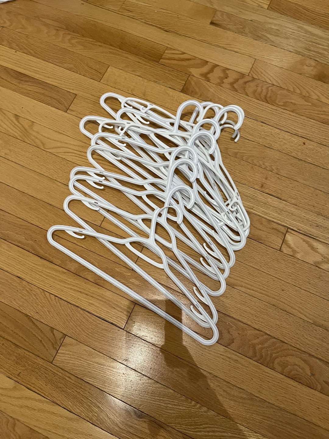 Bulk lot of white plastic hangers