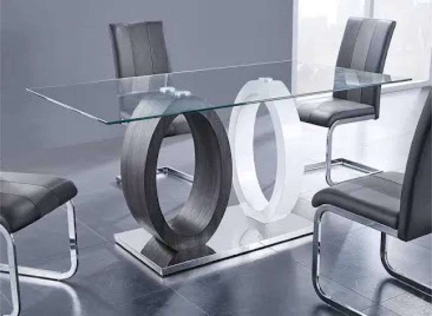 Glass-top dining table set with four grey chairs