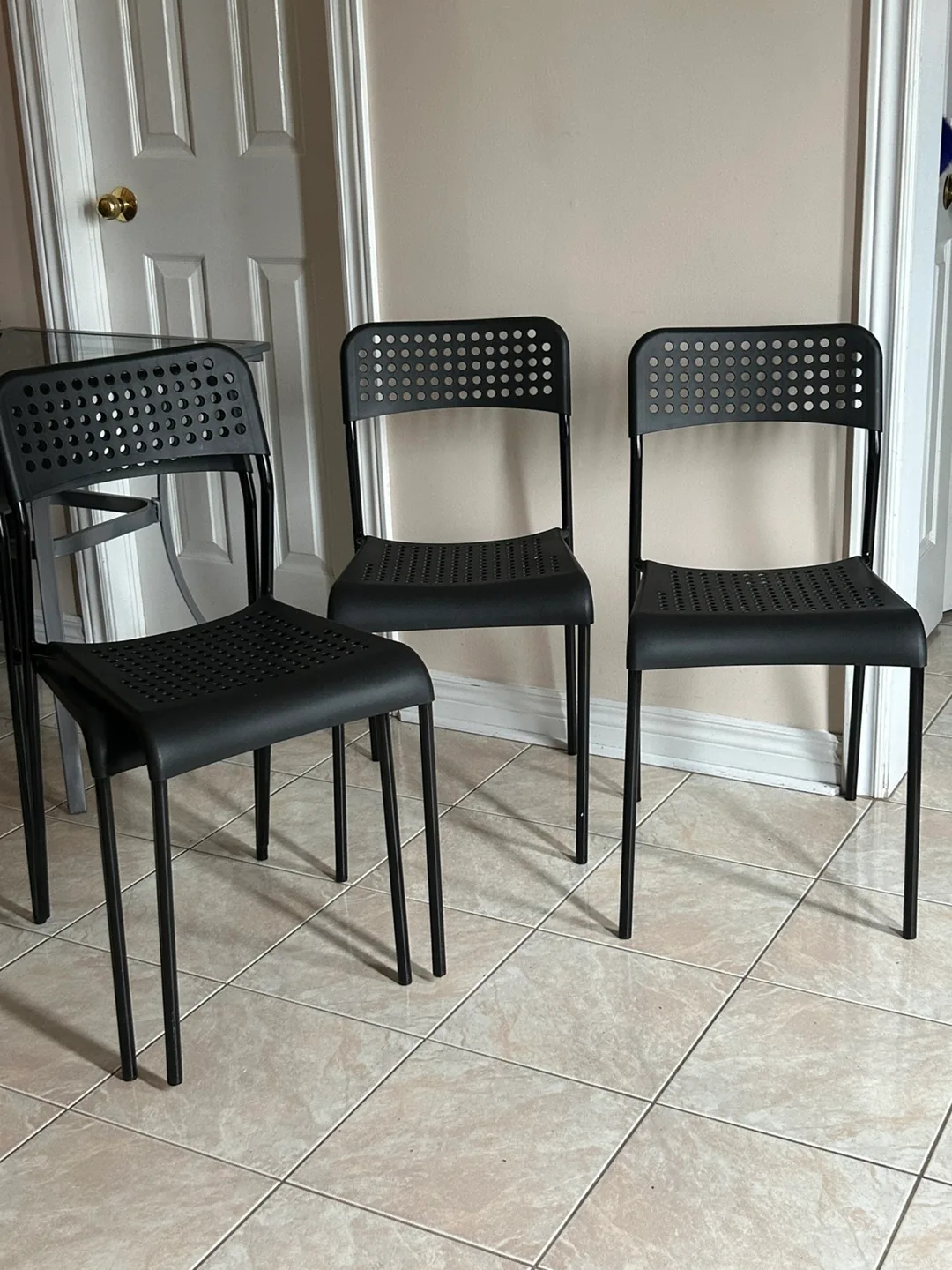 Four Black Plastic Chairs , Indoor / outdoor image indicator(2)