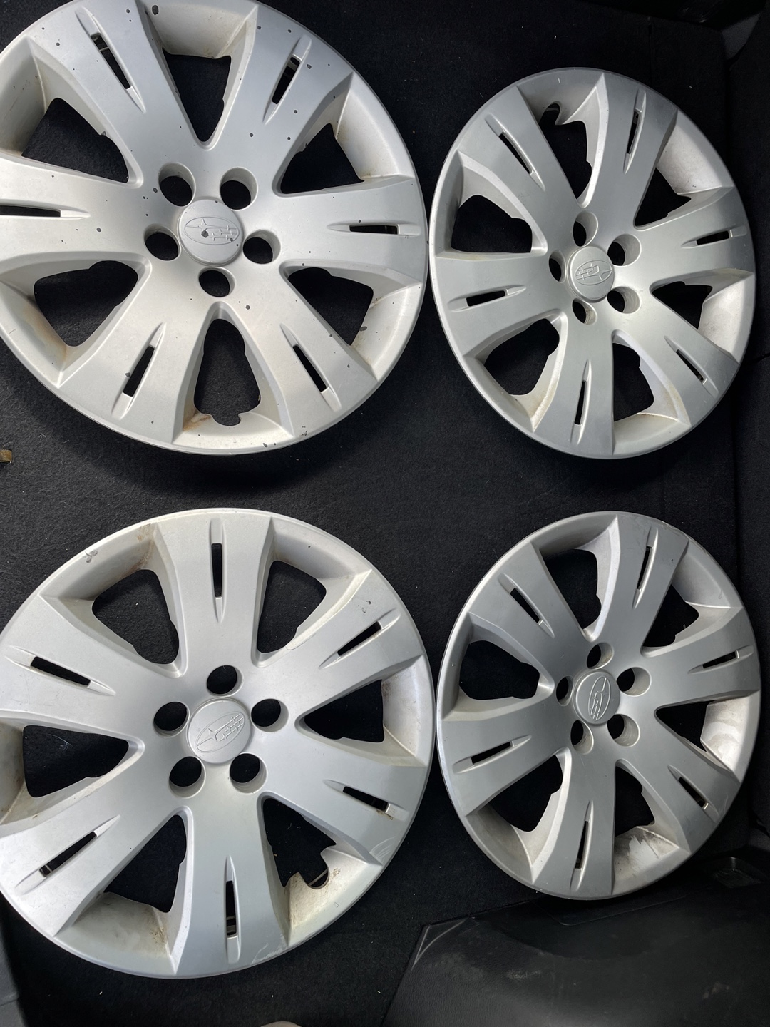 Set of four used Subaru hubcaps