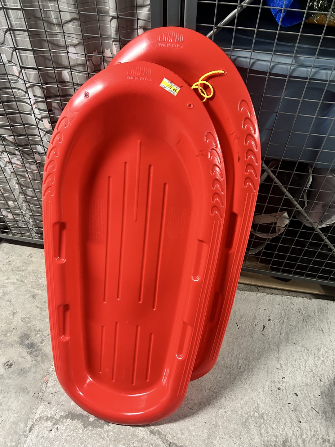 Two Red Plastic Sleds