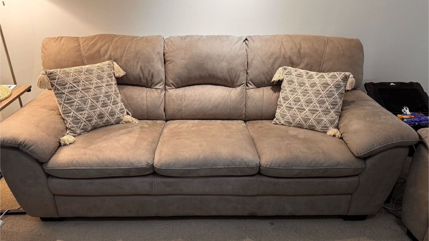 Beige Sofa with Two Throw Pillows