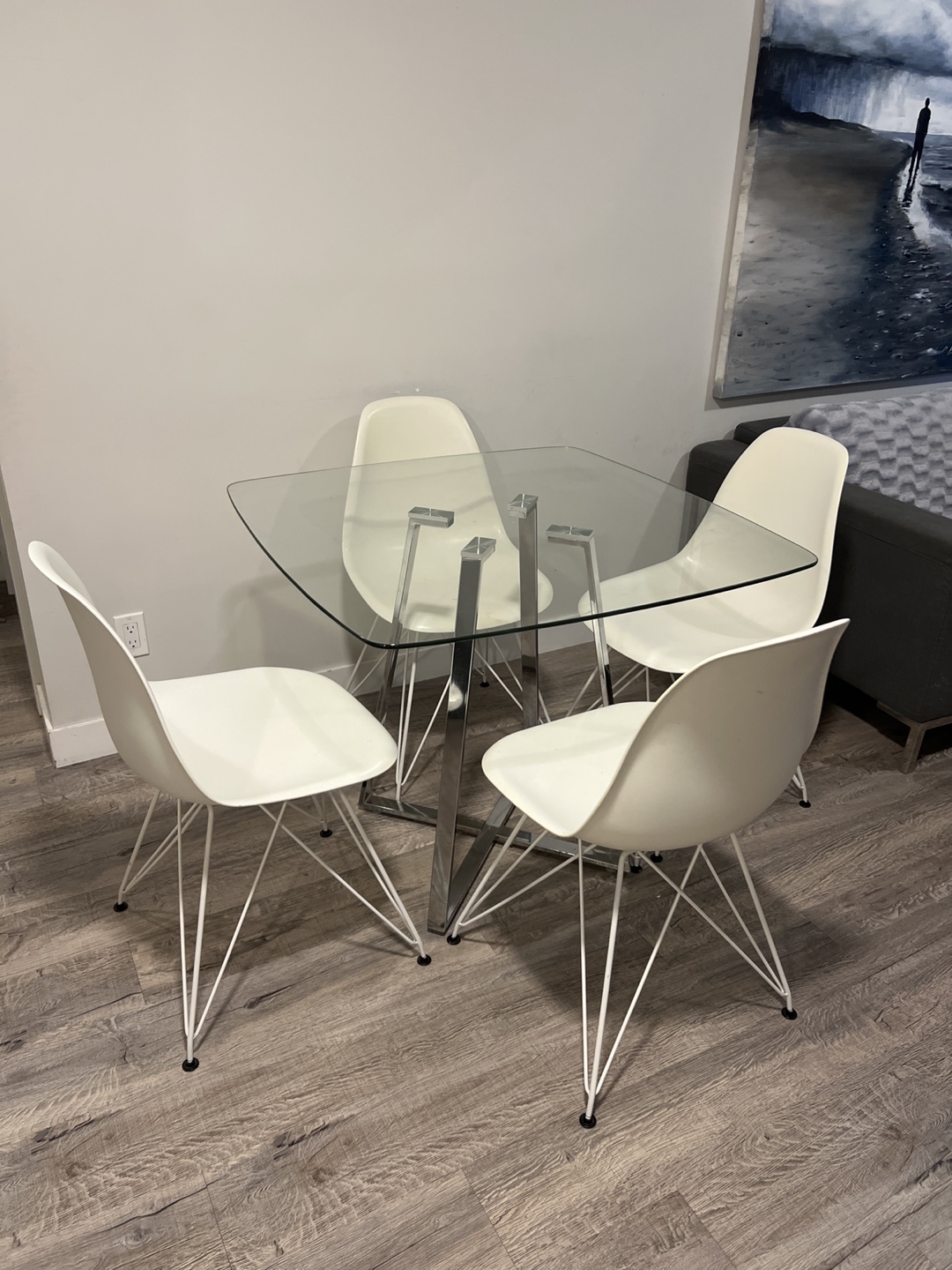 Glass Top Dining Table with Four White Chairs
