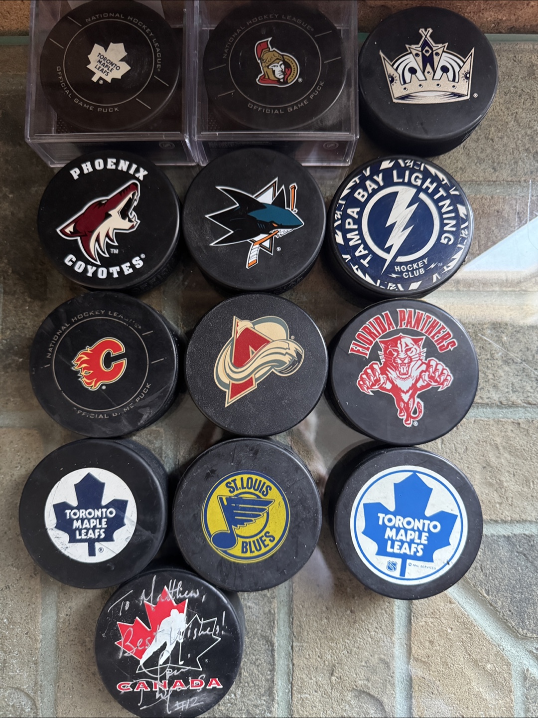 Collection of 12 NHL hockey pucks